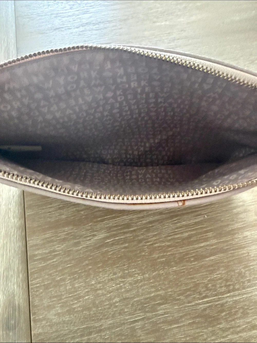 kate spade blush pink pebbled leather clutch with black tassel trim